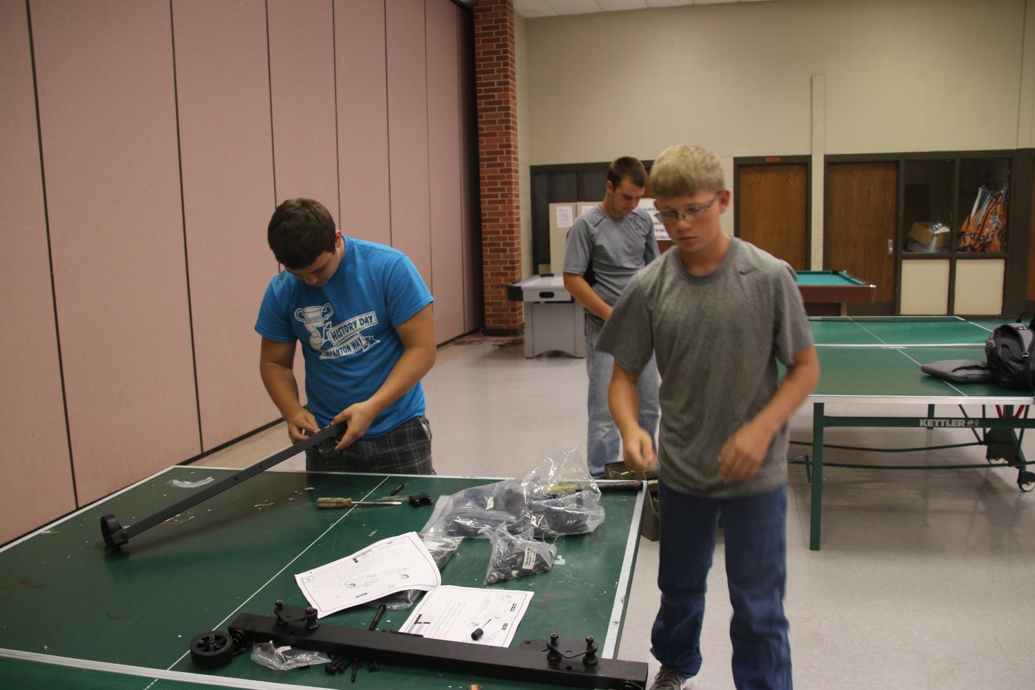 Jake Sinclair and Trevor Ross put the new table together Monday. 
