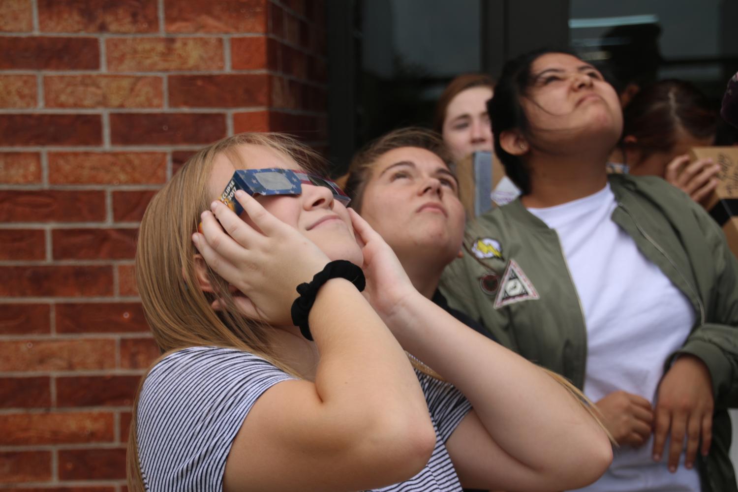 Kalissa Wile is looking at the eclipse during class, while Billie Cajero and Sabrina Gaines go blind. 
