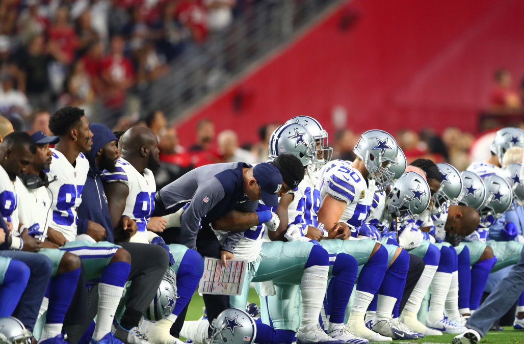 Sep 25, 2017; Glendale, AZ, USA; Dallas Cowboys players kneel together with their arms locked prior to the game against the Arizona Cardinals at University of Phoenix Stadium. Mandatory Credit: Mark J. Rebilas-USA TODAY Sports