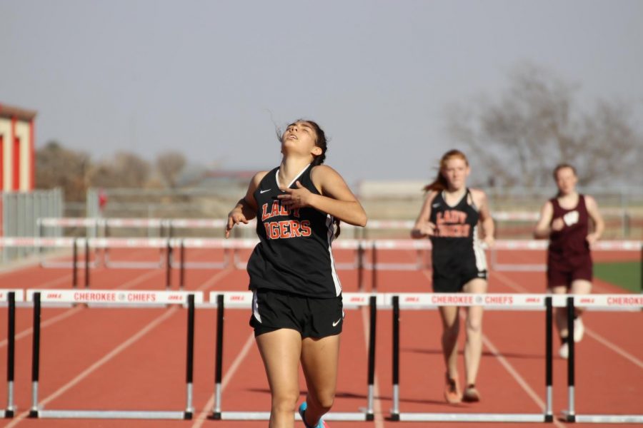 Jenny Delgado, CHS junior, completes her first hurdles of the year at the Cherokee track meet at Cherokee High School on March 15, 2018. Delgado didnt place this time but plans to practice for a better showing at the Okeene Meet in two weeks. 