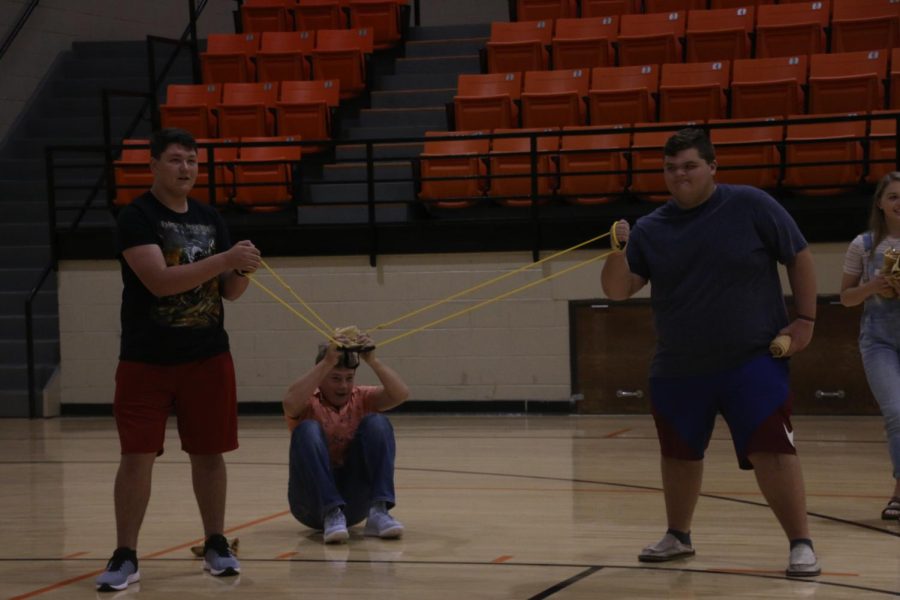 STUCO officers Caden Koehn, Beau Fuqua and Seth Bromlow use a giant slingshot to launch t-shirts into the stands. 