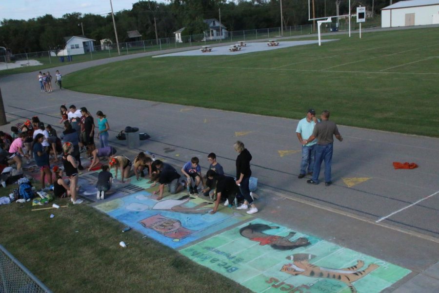In the final minutes of chalk art, Mr. Barney and Mr. Mesis try to pick a winner. 