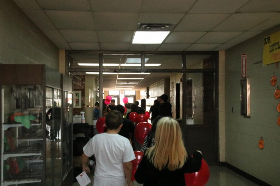 Students are walking down the hall getting ready for the balloon release.