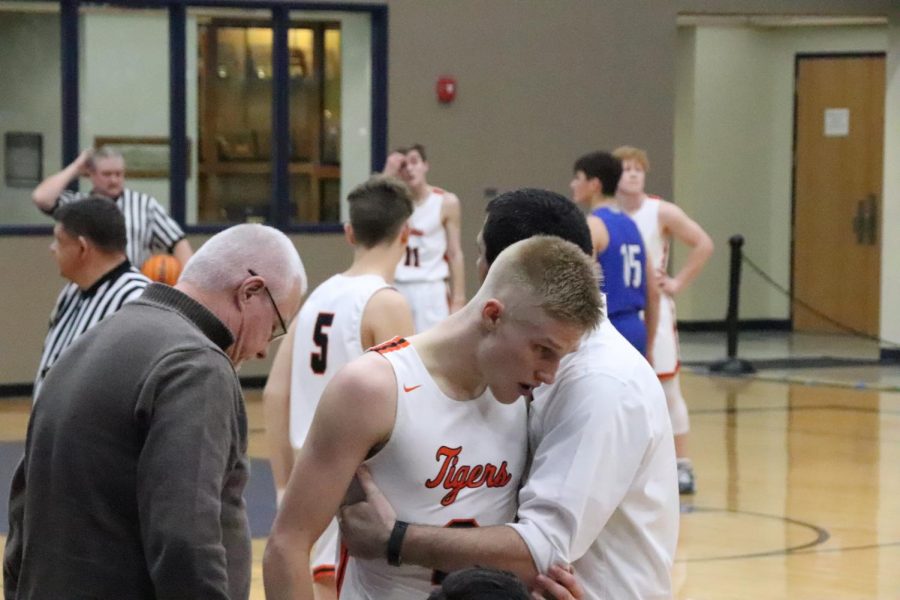 On Saturday, February 22 Claysen Scott, Coach Rich, and Assistant Coach Baldwin share a hug as Scott fouls out of his last high school game.