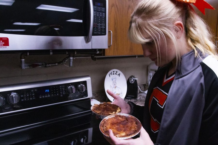 Kylie Nix tries to quickly choose the best pie for herself before the bell rings.