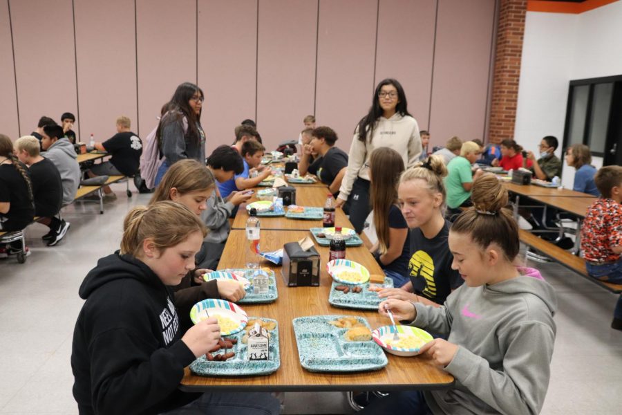 Seventh graders eating lunch together.