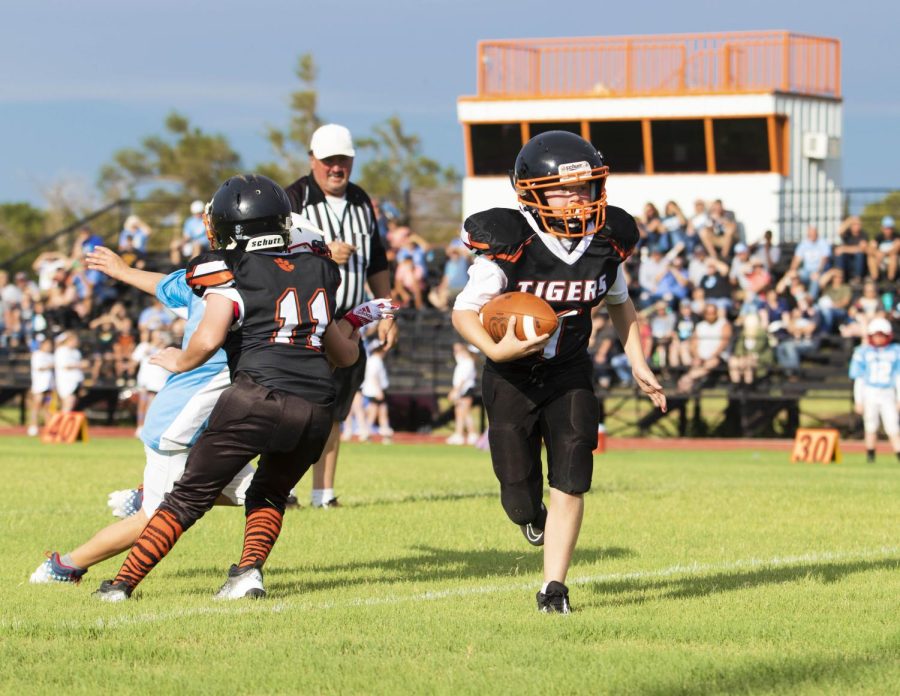 Caden Smith runs the ball before being taken down by the Okeene Whippets. 